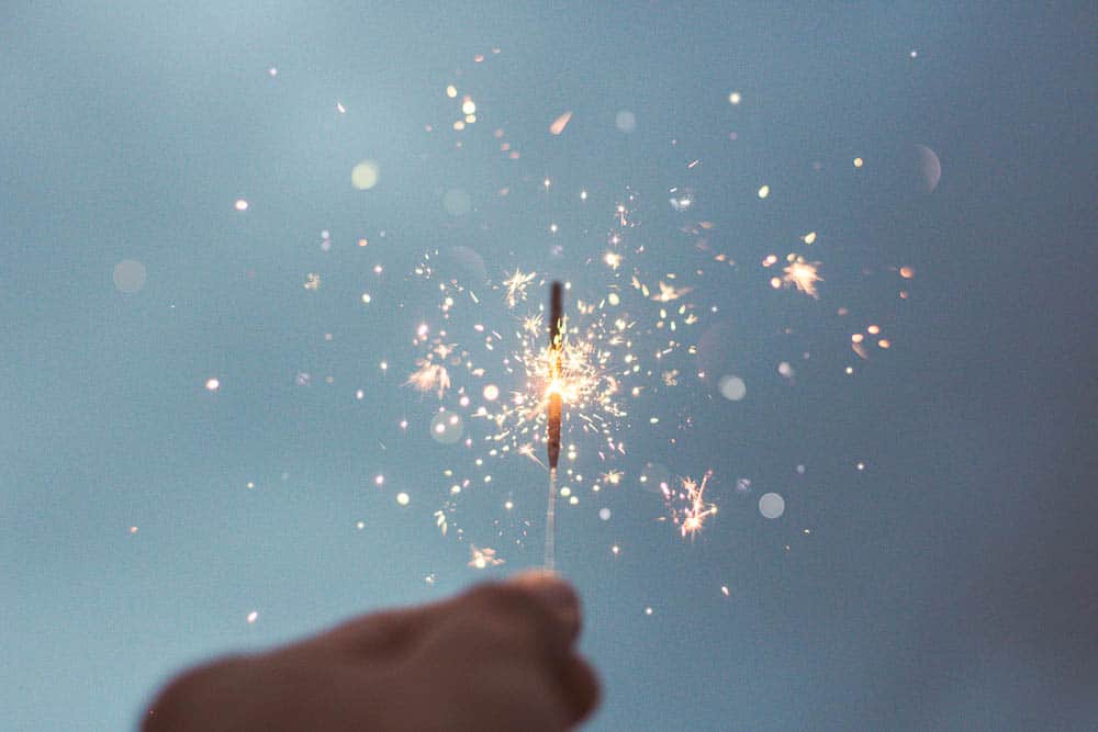 A close-up of a hand holding a sparkler